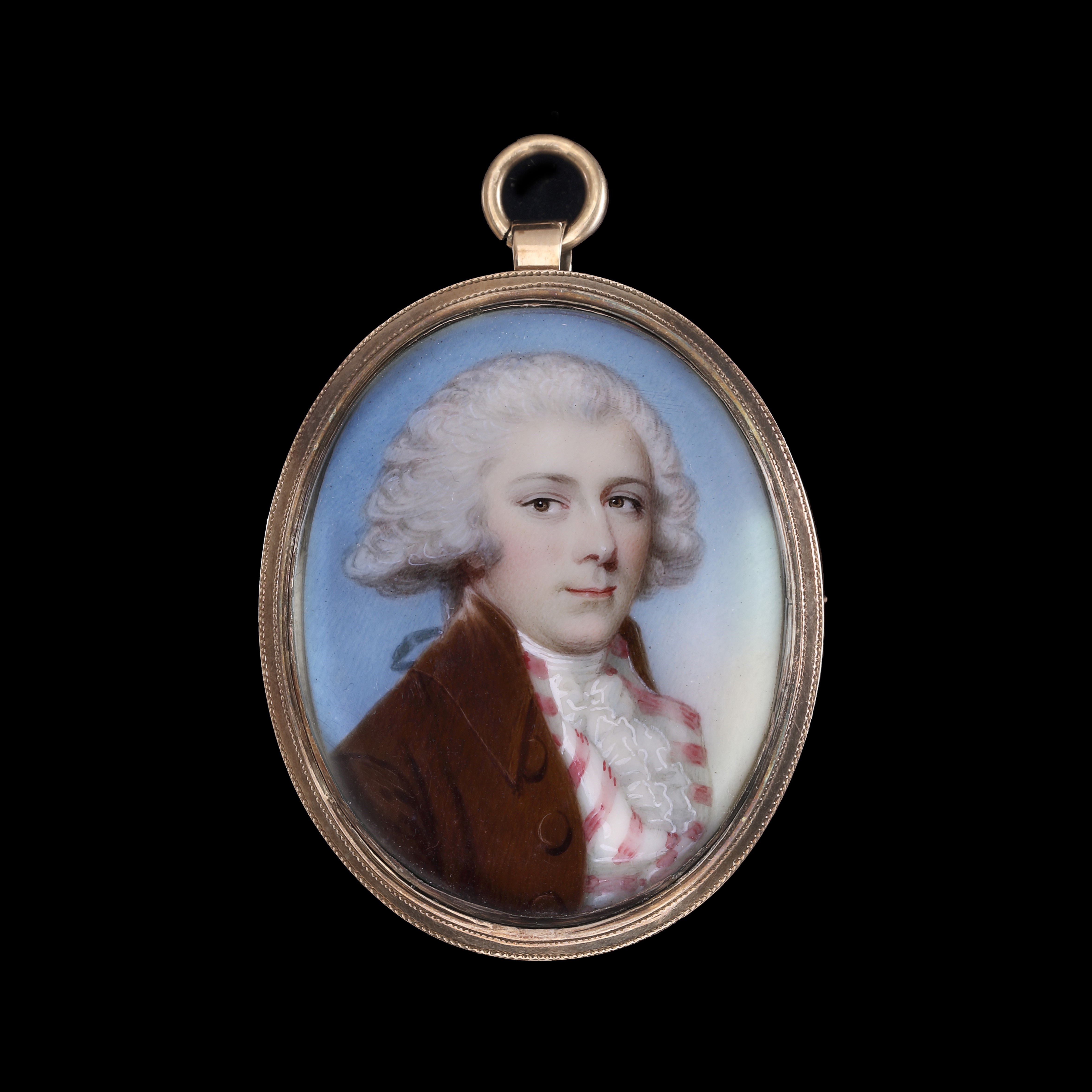 Portrait miniature of a Gentleman wearing a brown coat, a pink and white striped waistcoat, frilled cravat, his hair worn en queue